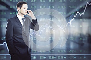 Stock market concept with trader talking to mobile phone on digital wall background with financial chart graphs, diagram and