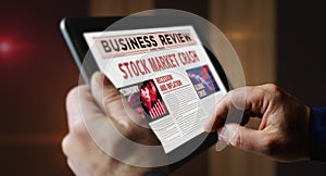 Stock market crash and business crisis newspaper on mobile tablet screen