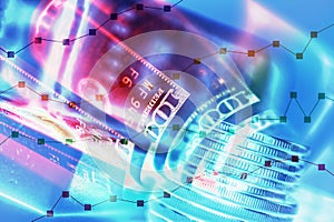 Stock market display or forex trading graph and candlestick chart on rows coins, banknote and gold.