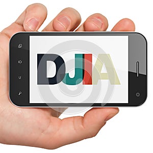 Stock market indexes concept: Hand Holding Smartphone with DJIA on display