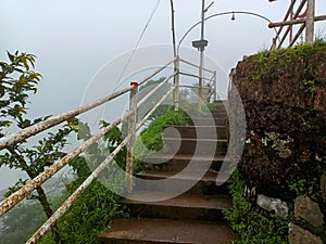 Stock photo of ancient staircase made by stone in the old Hindu temple sateri Mahadev mandir, there is white color iron stairs