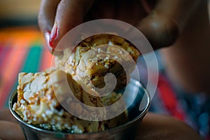 Stock photo of delicious healthy homemade peanut or groundnut chikki, also called as peanut candy. Indian sweet candy.