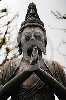 Stock photo depicts a bronze statue of the Buddha