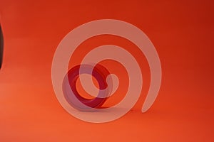 Stock photo of insulation or orange colored plaster in a circle. Isolated on an orange background.