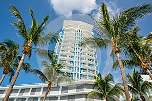 Stock photo Miami Beach condominium building on blue sky with palm trees