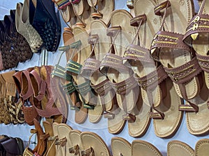 Stock photo of popular and traditional kolhapuri chappal display on wall for sale in the local shop.It is handmade leather chappal