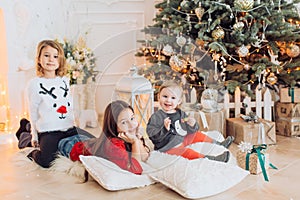 Portrait of three beautiful girls sisters in Christmas decorations