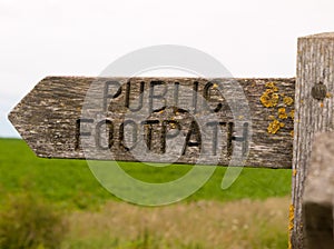 Stock Photo - public footpath wooden sign outside leading way co