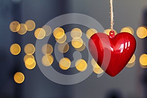 Stock photo of red plastic hearts hanging with an unfocused background