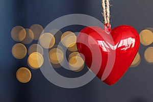 Stock photo of red plastic hearts hanging with an unfocused background