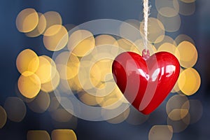 Stock photo of red plastic hearts hanging with an unfocused background