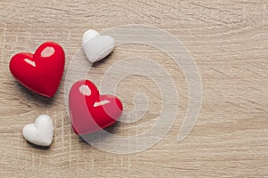 Stock photo of red and white hearts on a wooden background with space for text