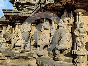 Stock photo of ruined ancient sculpture of Hindu trinity god sitting on elephant, idol carved out off gary color granite.