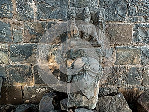 Stock photo of ruined ancient sculpture of Hindu trinity god sitting on elephant, idol carved out off gary color granite