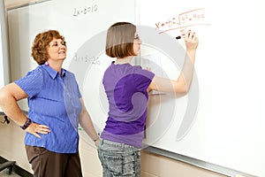 Stock Photo of Student and Teacher at Blackboard