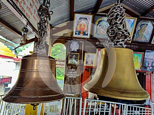 Stock photo of two anicnet big size copper or bronze metal bell hanging in the hindu temple on