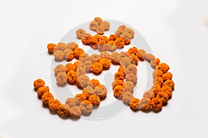Stock photo of word Aum or om made using marigold flower