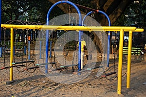 Stock photo of yellow and blue color painted climbing adventure equipment for kids, Picture captured at Rankala lake Kolhapur ,