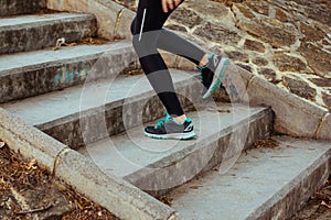 Stock photo of a young woman climbing stairs while running