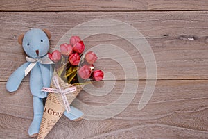 Stock photography flat lay plank table template blue bear doll holding rose flower