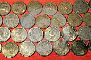 Stock pile of 1, 2, 5, 10 Indian rupee metal coin currency isolated on sack background. Financial, economy, Banking and exchange