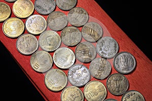 Stock pile of 1, 2, 5, 10 Indian rupee metal coin currency isolated on sack background. Financial, economy, Banking and exchange