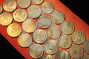 Stock pile of 1, 2, 5, 10 Indian rupee metal coin currency  on sack background. Financial, economy, Banking and exchange