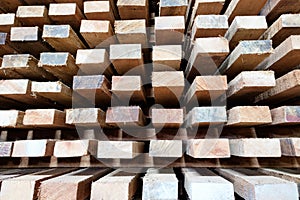 Stock of timber wood construction in warehouse.