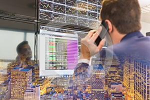 Stock trader looking at computer screens.
