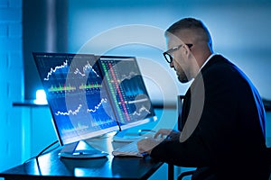 Stock Trader Man Using Multiple Computers
