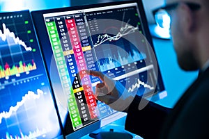 Stock Trader Man Using Multiple Computers