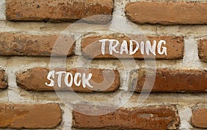 Stock trading symbol. Concept words Stock trading on beautiful brown brick wall. Beautiful brown brick wall background. Business