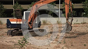 Stock Video Footage 1920x1080 Excavator on a construction site equates land clearing a building site, excavator bucket working.