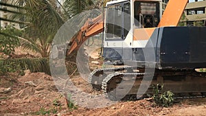 Stock Video Footage 1920x1080 Excavator on a construction site equates land clearing a building site, excavator bucket working.