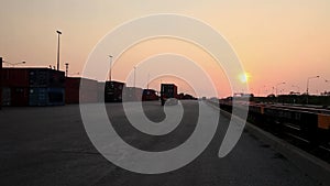 Stock Video Footage 1920x1080 Truck Sunset Container Cargo. Truck transports container rides into the sunset. Delivery of goods