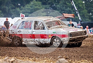 Stockcar drives on a dirty track at a Stockcar challenge.