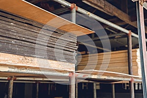 Stocked plywood sheets of differing thickness at an open-air hardware store photo