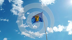 The Stockholm flag flutters in the sky on a cloudy day.