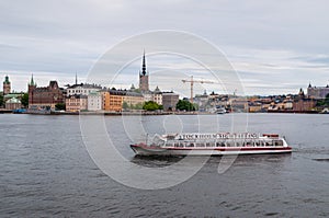 Stockholm Sightseeing Boat With Cityscape in Background in cloud