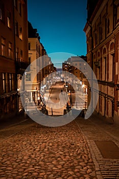 Stockholm, Sweden. Cobbled street in Sodermalm. Color street with cobblestone road, streetlight. Narrow street.