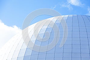 the Globen arena in bright sunlight and blue sky