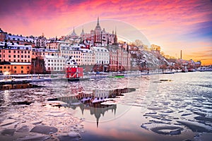 Stockholm, Sweden. Sunset with Mariaberget downtown and frozen Lake Malaren