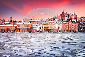 Stockholm, Sweden. Sunset with Mariaberget downtown and frozen Lake Malaren