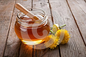 StockImage Jar filled with honey on wooden table, golden sweetness displayed