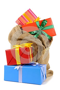 Stocking bag filled with lots of Christmas gifts isolated on white background