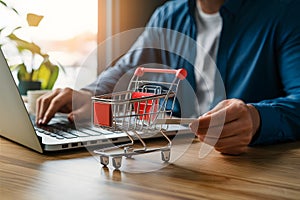 StockPhoto Shopping cart and credit card placed on laptop desk photo