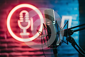 StockPhoto Studio podcast microphone on blurry neon background, broadcasting equipment photo