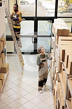 Stockroom employee scanning boxes using store scanner