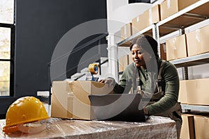 Stockroom worker analyzing goods inventory report