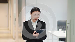 Stocktaking. Young professional woman auditor making inventory at company office, writing notes in clipboard